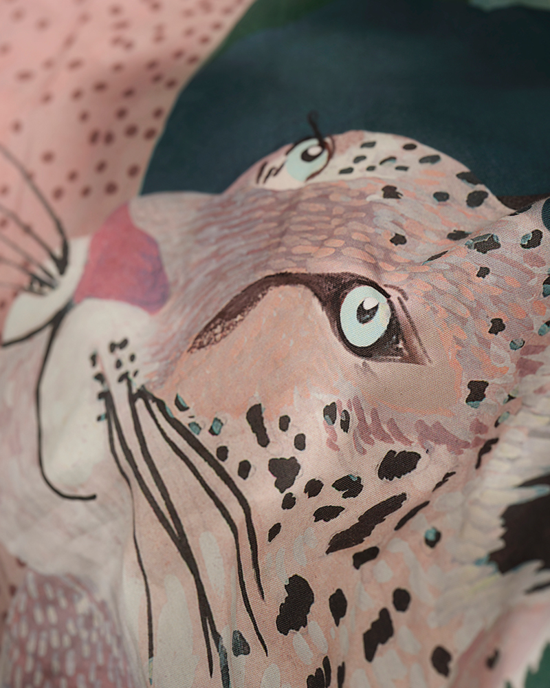 A close-up of the hand-painted snow leopard design on ALPTALL duvet cover.