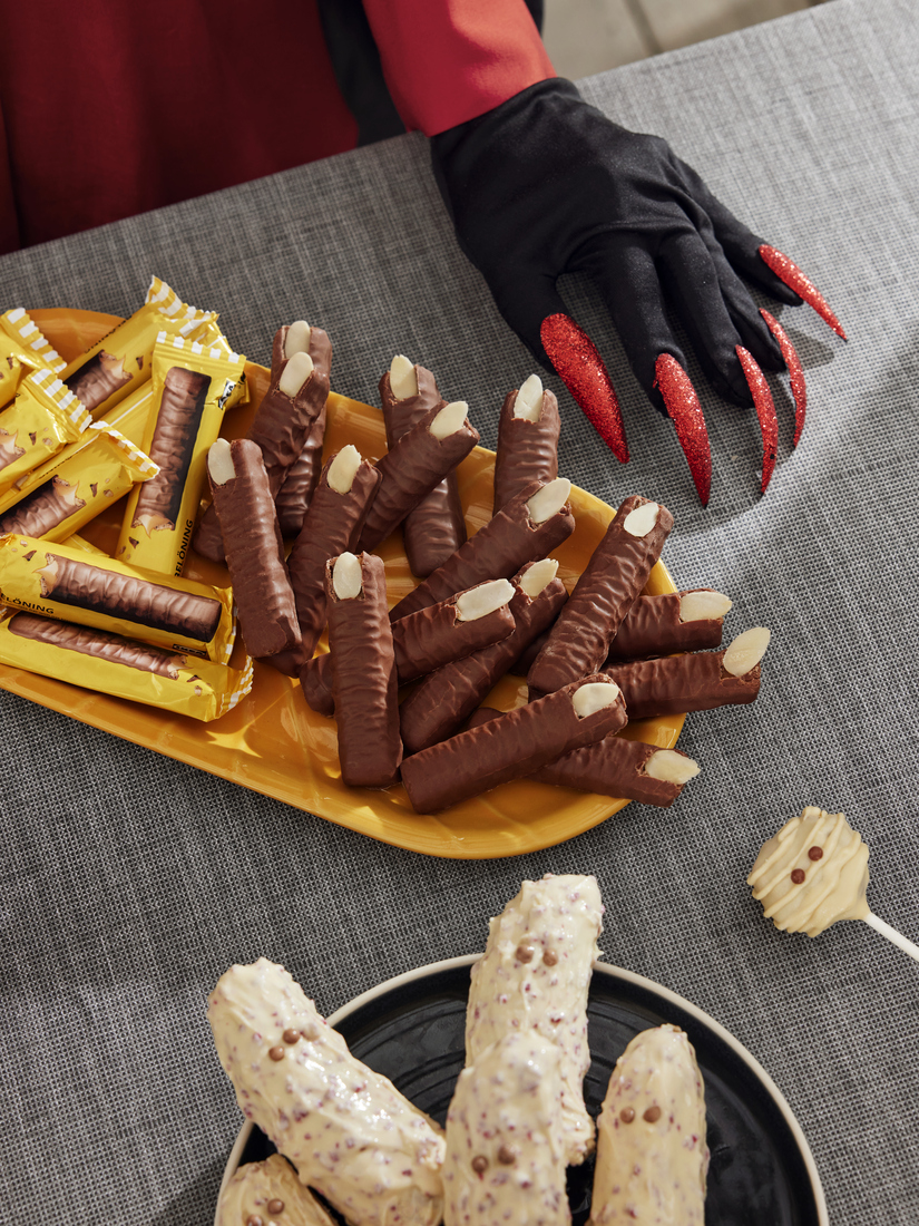 Chocolate biscuits with almonds shaped like witch fingers for Halloween.