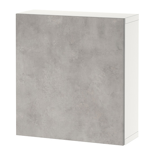 Un mueble de almacenaje BESTÅ blanco con puerta gris efecto cemento. Es rectangular y tiene un diseño moderno.