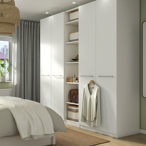Dormitorio minimalista con armario PAX, cama y ventana.