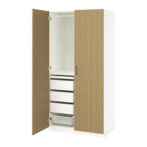 A white and oak PAX wardrobe with drawers and shelves.