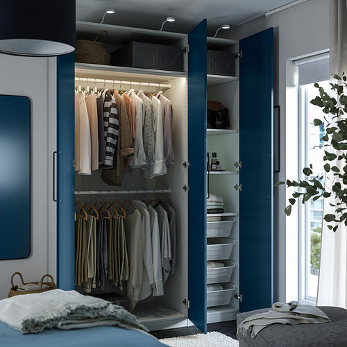 A modern closet with blue doors open, revealing hanging clothes, shelves, and baskets, designed to maximize storage space.