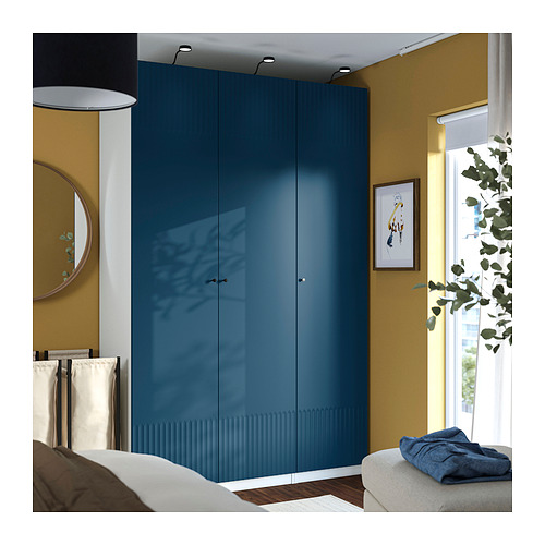 Teal PAX wardrobe in room, glossy finish, plant by window.
