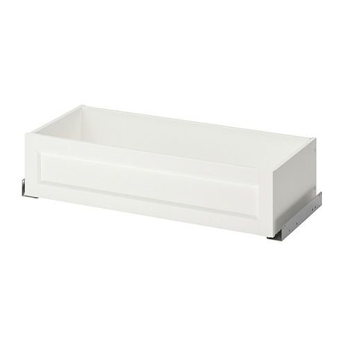 A white KOMPLEMENT wardrobe drawer with a sleek design, featuring a framed front, metal glides, and a clean, rectangular shape.