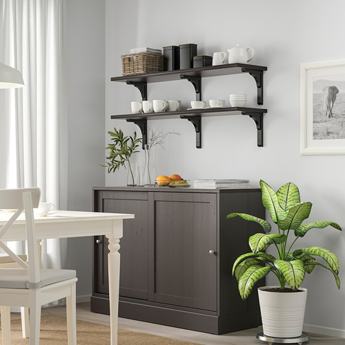 Modern dining room with dark wood cabinet, white chairs, plant, and tableware shelves.