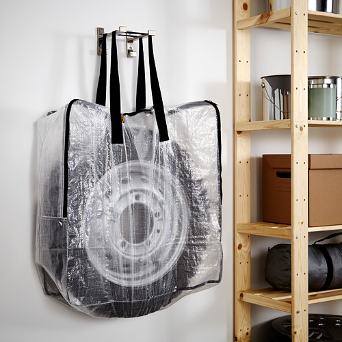Bolsa translúcida para colgar en la pared con asas negras, para neumáticos, equipo o ropa. Se pliega en vacío.