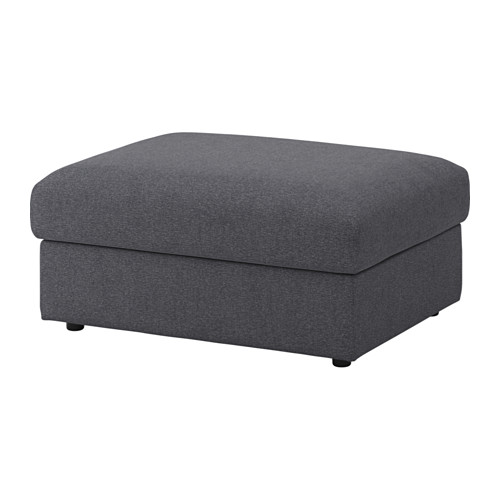 Una otomana de almacenamiento VIMLE en color gris, con un diseño rectangular afelpado y robustas patas negras.