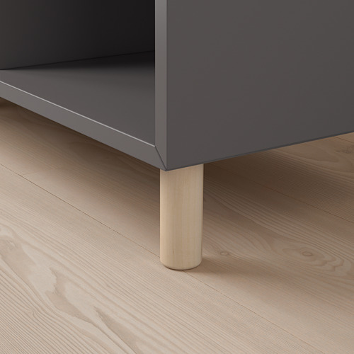 Gray storage unit with wooden legs on a light wooden floor. Quality materials and minimalist design.