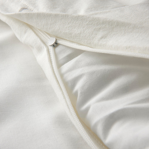 Close-up of soft, white baby duvet with zipper detail.