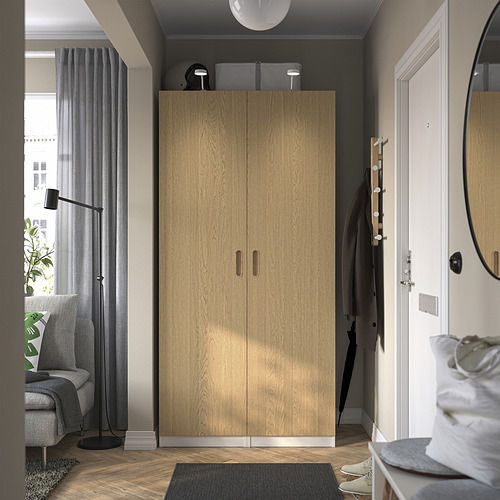 Modern room with light wood PAX wardrobe, gray decor, and entrance mat.