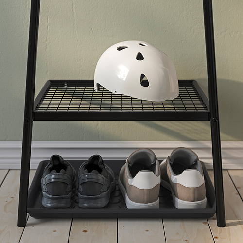 El zapatero de metal negro guarda dos pares de zapatillas y un casco blanco en el estante superior, perfecto para los pasillos.