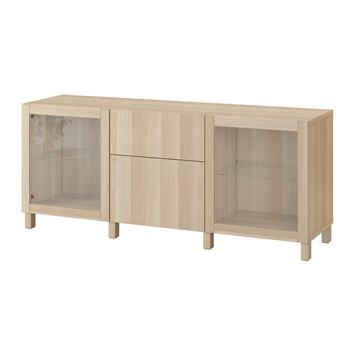 Ikea BESTÅ light brown wooden storage unit with glass doors and drawers.