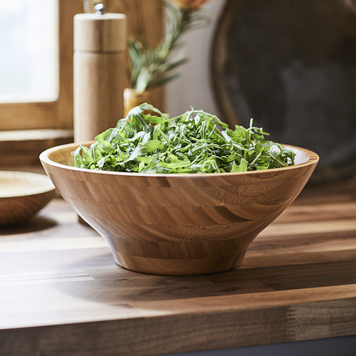 Cuenco de madera con ensalada en la mesa.