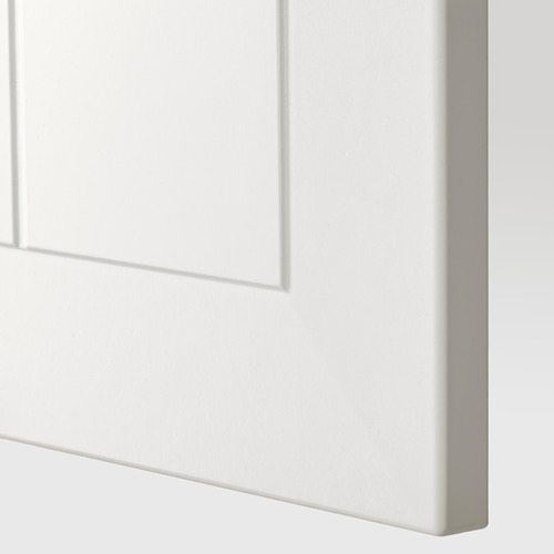 Un primer plano de la puerta de un armario blanca, lisa y robusta con líneas limpias, que forma parte de un sistema de cocina METOD.