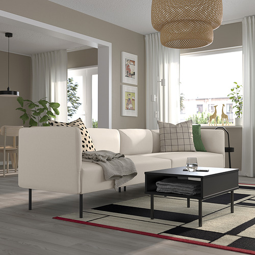 Modern living room with LILLEHEM sofa, cushions, coffee table, side table with plant, and large rug.