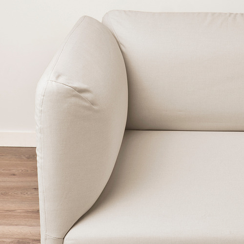 Minimalist beige sofa, plush cushions, sturdy wooden floor.