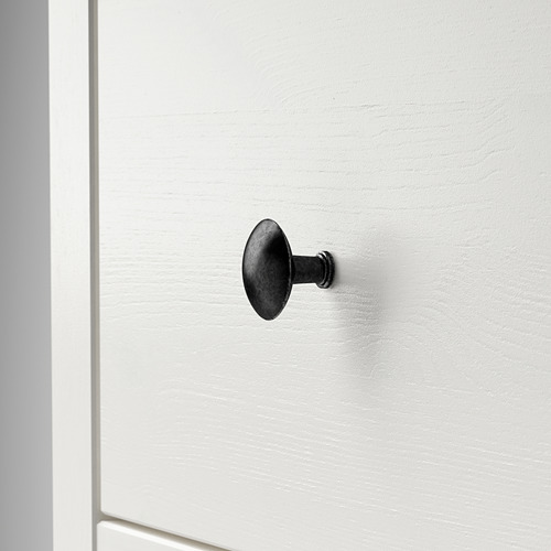 Un solo gancho de metal oscuro montado en puerta blanca lisa. Diseño simple, resistente y elegante.