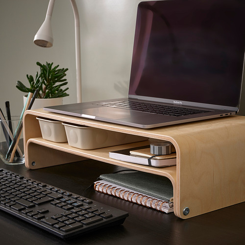 VATTENKAR laptop stand with macbook, containers, and notebook.