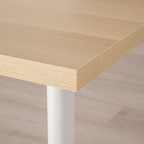 Wooden tabletop with metallic leg, showcasing smooth finish and sturdy support.