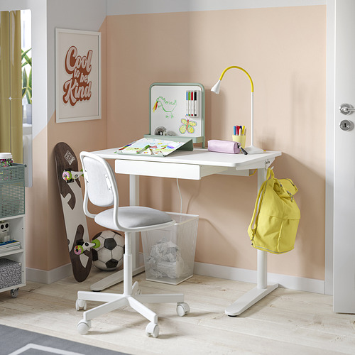 Escritorio de estudio blanco para niños con pizarra magnética, silla ajustable, mochila amarilla, accesorios deportivos y póster motivacional.