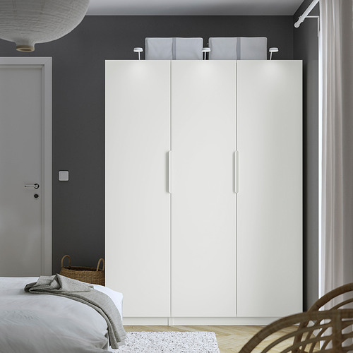 Minimalist bedroom with large white PAX wardrobe, gray walls, and wicker basket beside door.