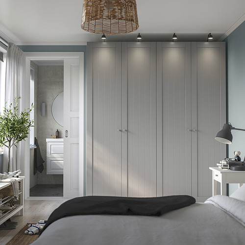Dormitorio moderno con armario PAX gris, iluminación integrada y un ambiente acogedor realzado por lámparas colgantes y de noche.