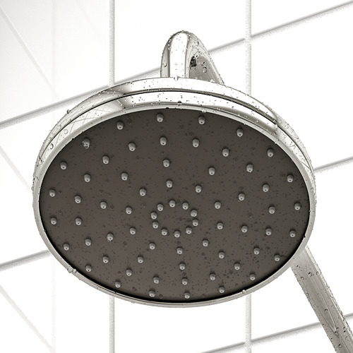 Shower head with full spray function, showing water droplets, mounted on a tiled wall.