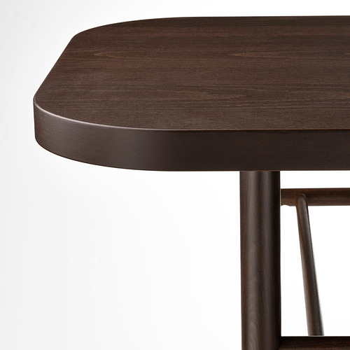 Primer plano de una mesa de madera oscura con bordes elegantes y curvos y robustas patas de metal, que ilustran la artesanía de alta calidad y el diseño duradero.