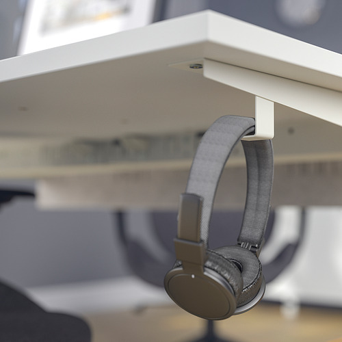 Si no puedes verlo, muestra un escritorio blanco con una característica inteligente: los auriculares cuelgan perfectamente de su gancho, manteniendo el espacio de trabajo ordenado y organizado.