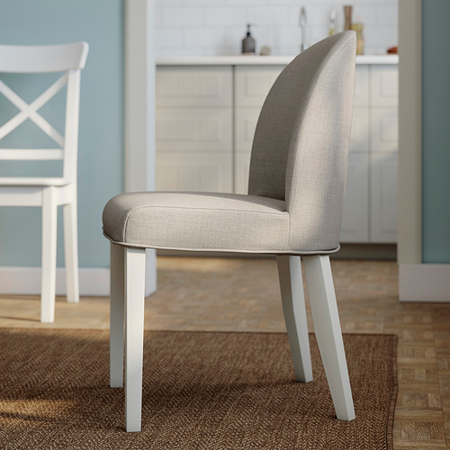 Modern grey fabric dining chair with white legs, supportive foam cushioning, elegant curved back in kitchen setting.