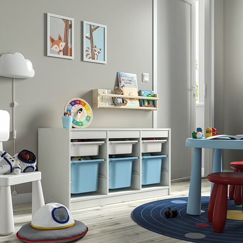 Sala de juegos con unidades de almacenamiento TROFAST con contenedores azules, reloj colorido y arte infantil.