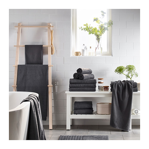 Baño con toallas VÅGSJÖN en escalera y estantería, plantas, decoración y bañera.