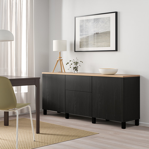 Modern room with BESTÅ sideboard & coastal photo.
