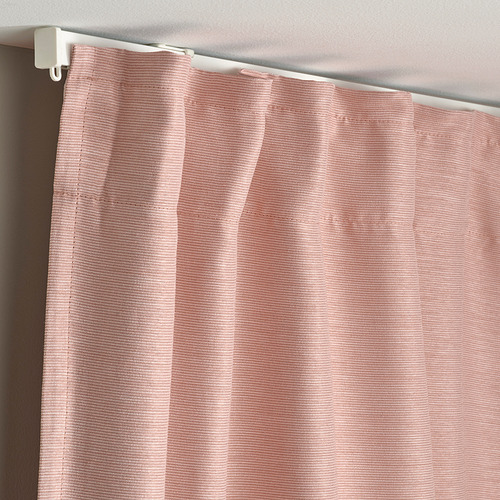 Close-up of pink VILBORG curtains with linear texture on rod, demonstrating their room darkening feature and pleated design.