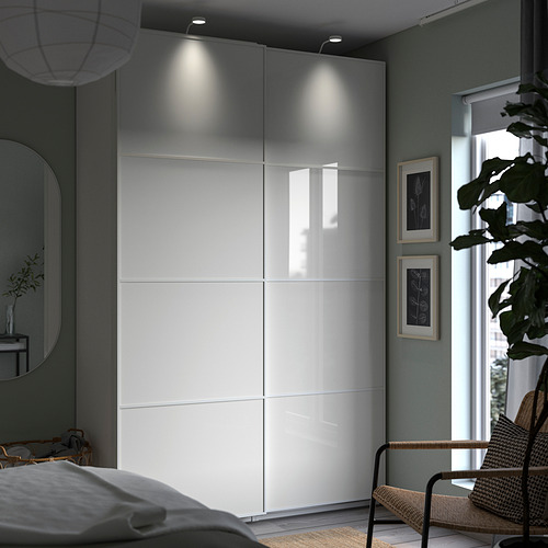 Modern bedroom with white PAX wardrobe, glass doors, and mood lighting.