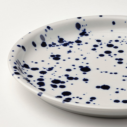Placa de gres blanco con motas azules dispersas, borde liso.