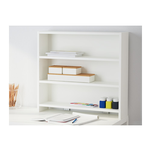 A white desk with top shelf storage. Holds books, papers, and art supplies neatly.