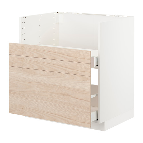 Un mueble de cocina METOD blanco con puertas y cajones con motivos de madera de fresno claro. Tiene forma rectangular con superficies lisas y cajón integrado.