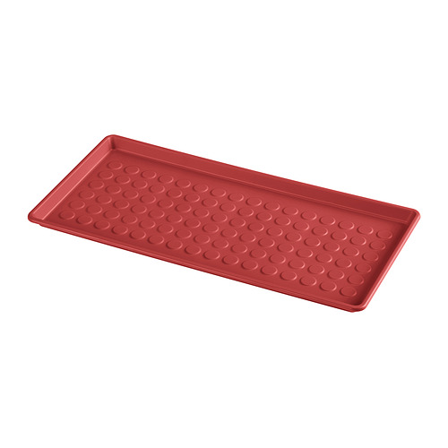 Alfombrilla rectangular de polipropileno rojo con motivos circulares.