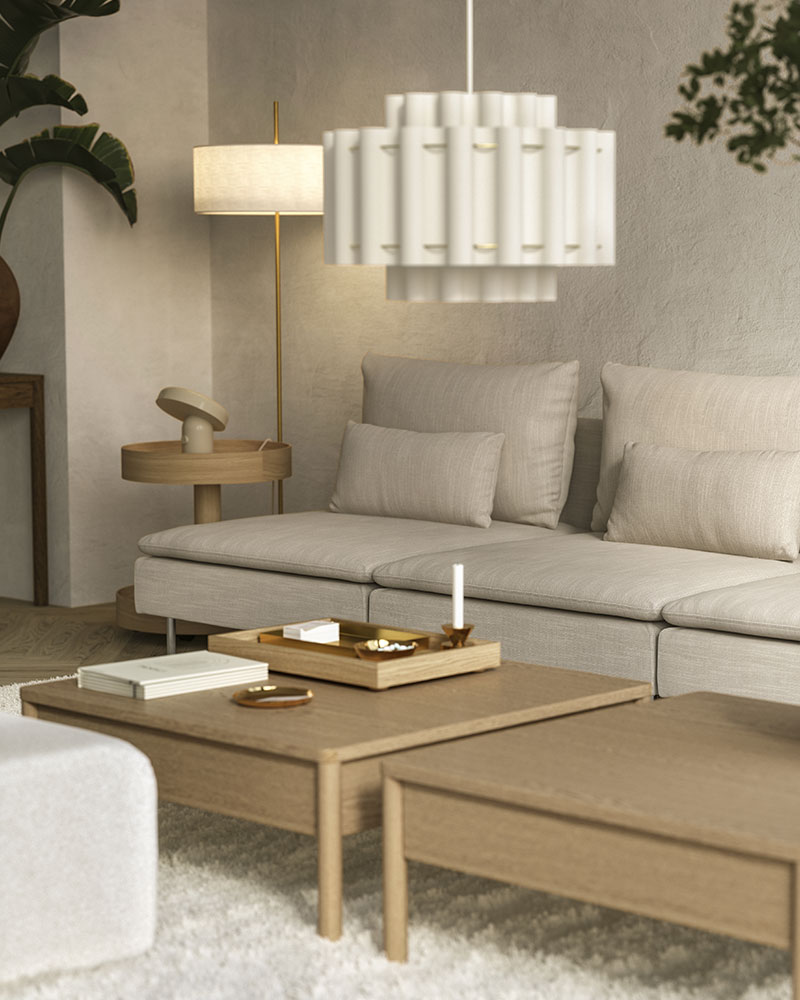 A living room in a model home has a beige SÖDERHAMN modular sofa made of three 1-seat sections by two low coee tables.