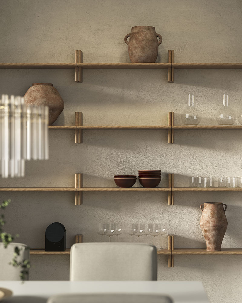 Side-by-side KLAVRESTRÖM wall shelves in solid oak with stretched h-shapes hold glassware, bowls and vases by a dining area.