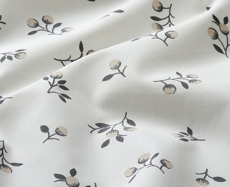 White fabric with small floral pattern. Neutral tones.