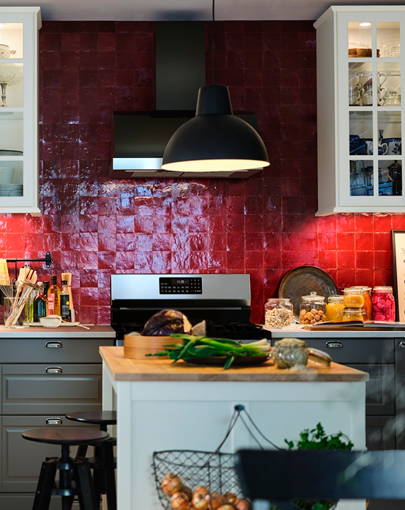 Rustic kitchen with SKURUP pendant lamp, TORNVIKEN workbench, DALFRED stool, ENERYDA handles, and KORKEN jars.