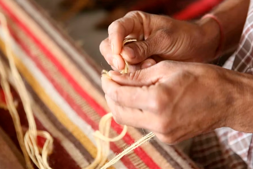 A person weaving handmade textiles