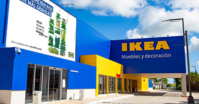 Blue IKEA store facade featuring a large billboard displaying kitchen containers.