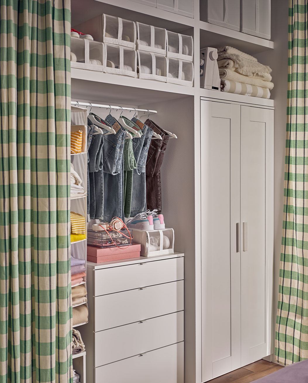 Bedroom closet, with accessories for organizing bedroom clothes, all covered with a green checkered curtain.