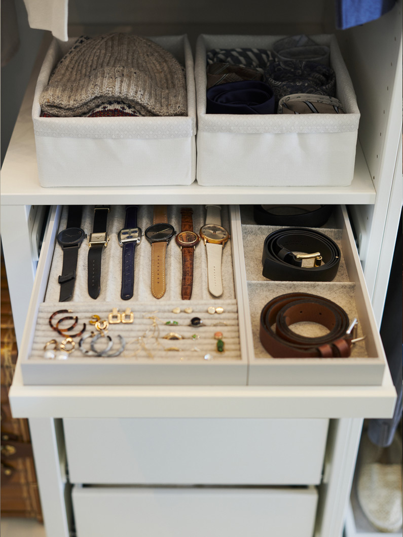Organized closet with light-toned accessory drawer, creating a neat and functional ambiance.