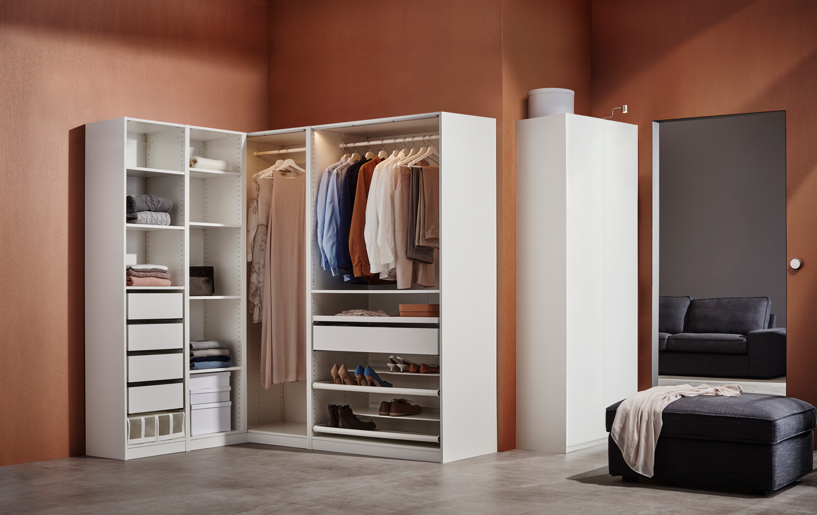 Spacious white walk-in closet with lighting, organized clothes and accessories, creating an elegant, functional ambiance.