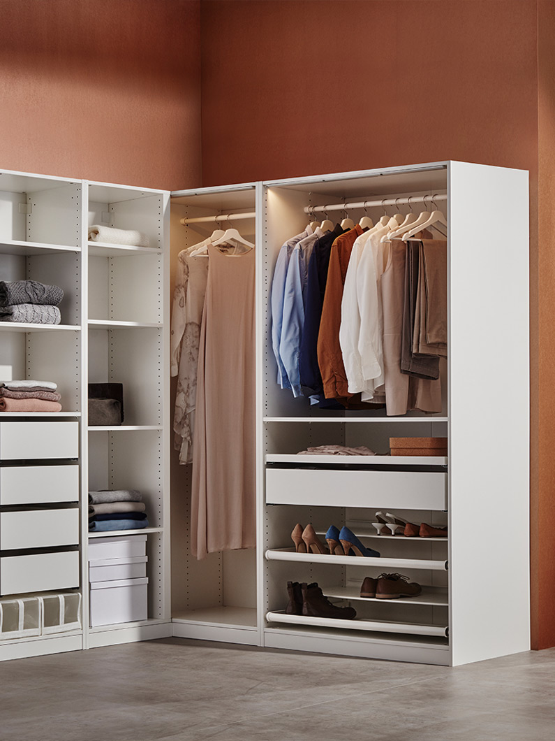 White corner wardrobe with organized clothes, shelves, and drawers, modern and warm ambiance.