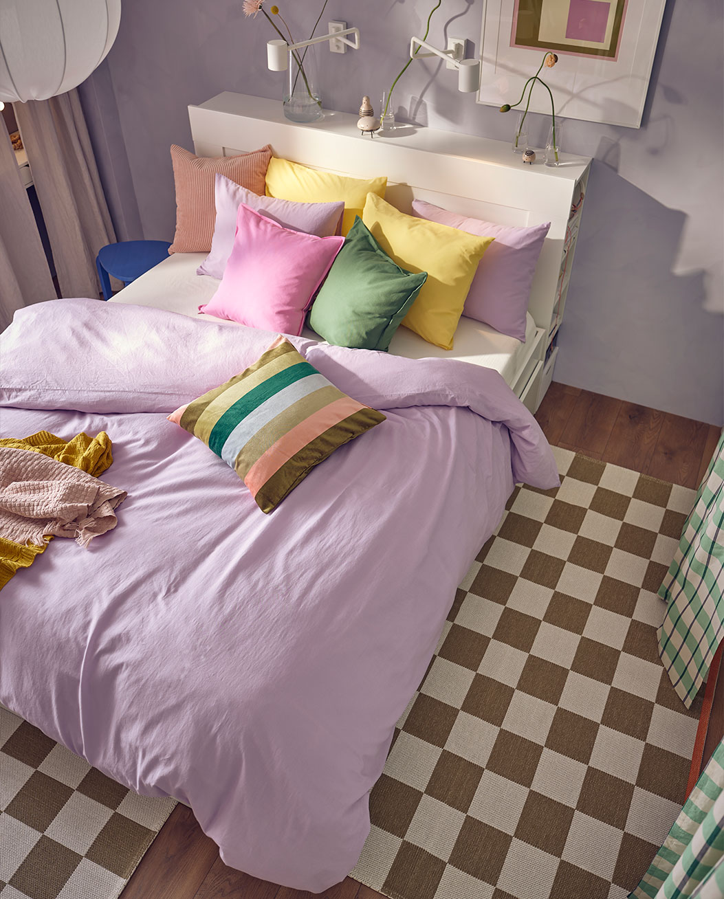 top view, of the whole colorful room, with its cushions and soft purple cover